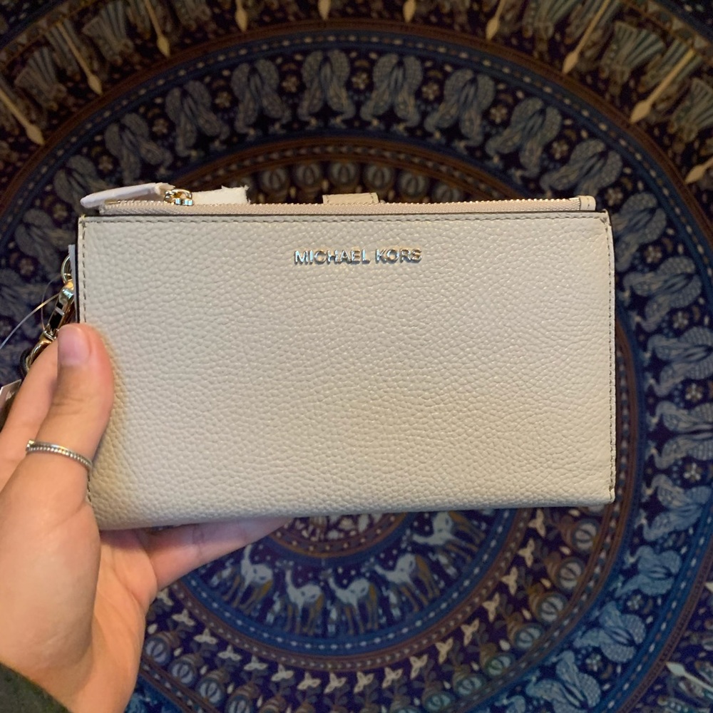 Michael Kors Jet Set Leather wristlet in light sand color.
